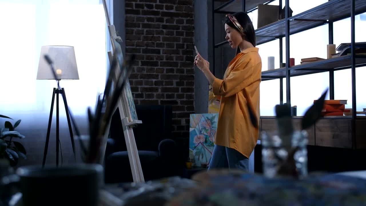 Stock Footage Young Painter Smiling As She Takes A Photo Live Wallpaper Free