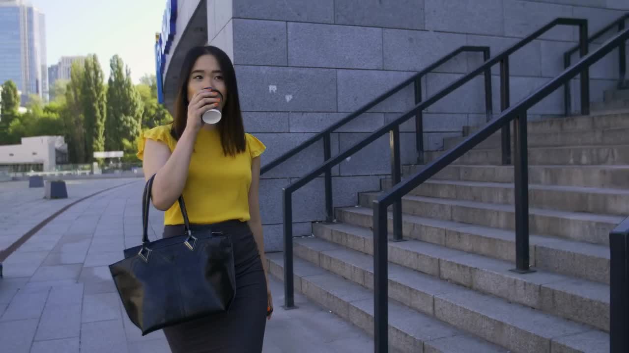 Stock Footage Woman Drinking Coffee While Walking To Work Live Wallpaper Free
