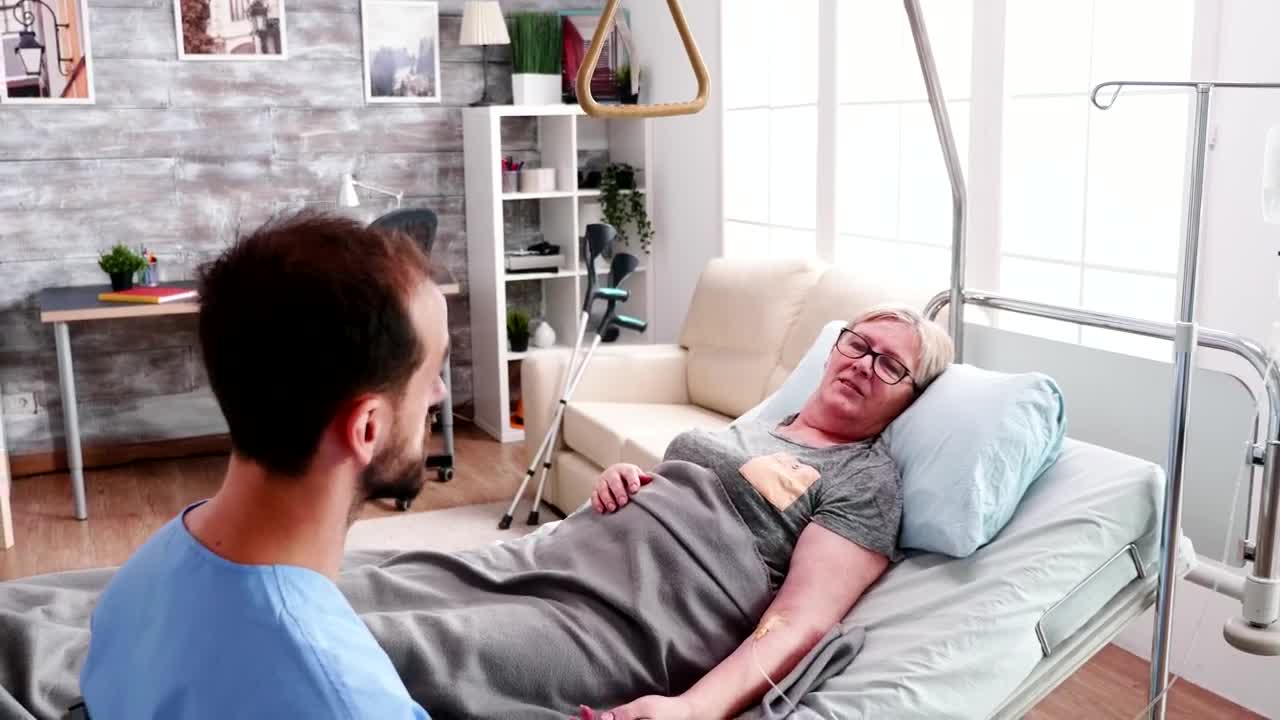 Stock Footage Woman In Hospital Bed Comforted By Nurse Live Wallpaper Free
