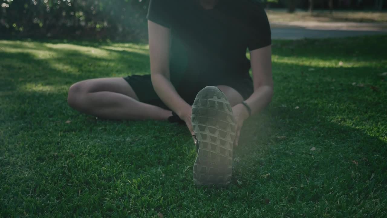 Stock Footage Woman Sitting In A Park Stretching Her Body Live Wallpaper Free