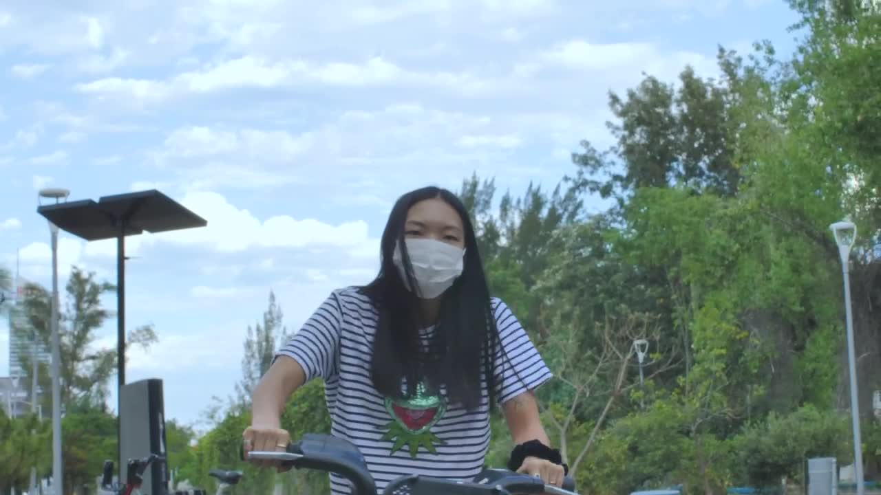 Stock Footage Woman With Mask On Bicycle In A Park Live Wallpaper Free