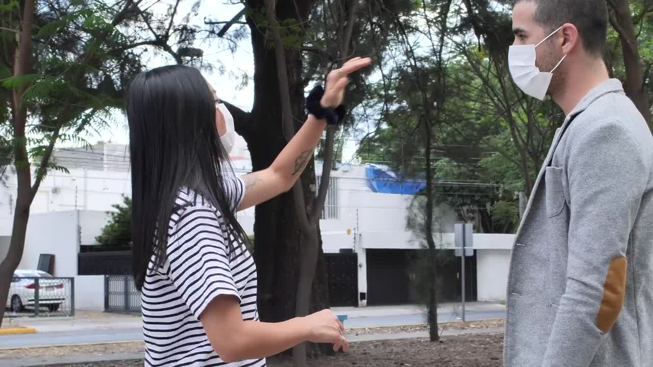 Stock Footage Woman Giving Directions To A Man With A Face Mask Live Wallpaper Free