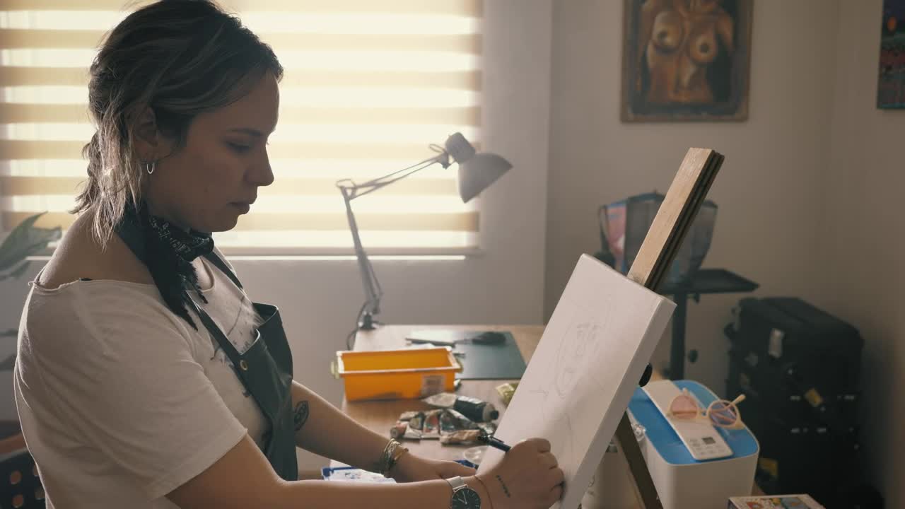 Stock Footage Woman Drawing On A Painting In Her Home Studio Live Wallpaper Free