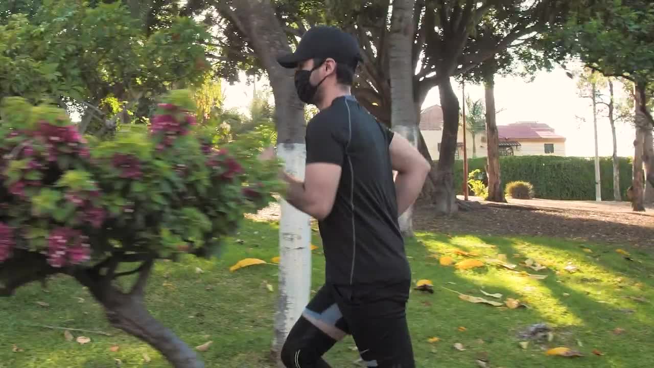 Stock Footage Young Man With Face Mask Running In A Park Live Wallpaper Free