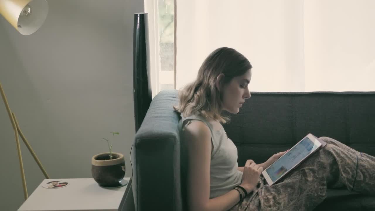 Stock Footage Young Woman On Her Ipad Lying On An Armchair Live Wallpaper Free