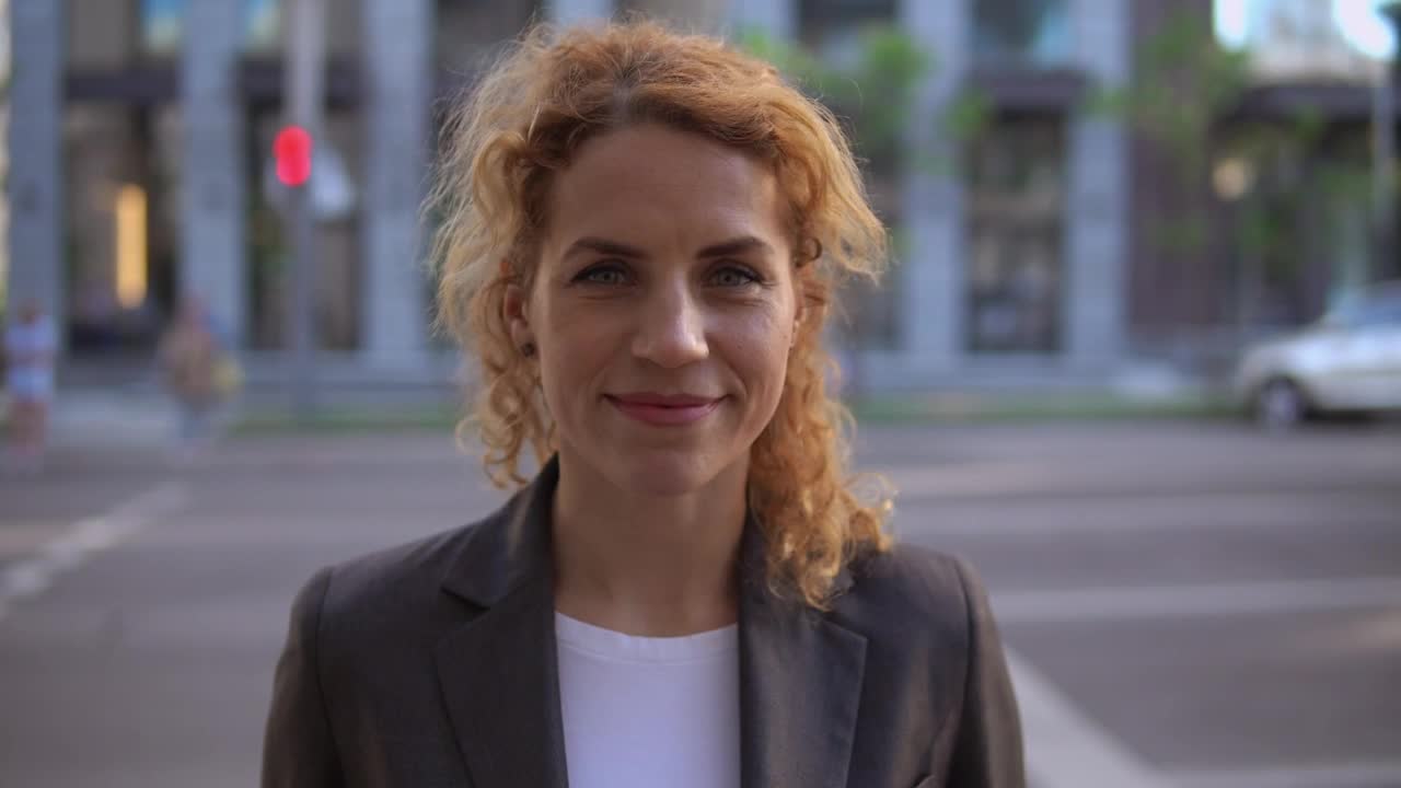 Stock Footage Woman In Blazer On The Street Smiling In The Foreground Live Wallpaper Free
