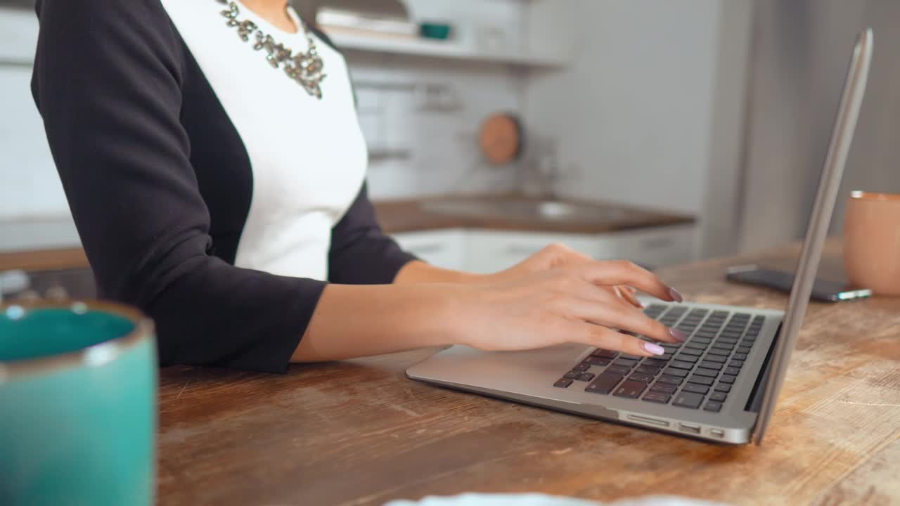 Stock Footage Woman Working On A Computer In A Kitchen Live Wallpaper Free