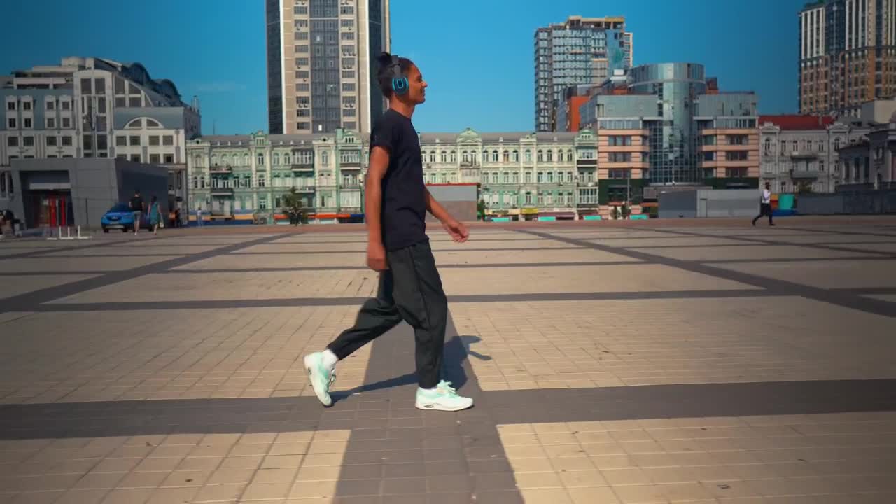 Stock Footage Young Man Walking Listening To Music From His Headphones Live Wallpaper Free