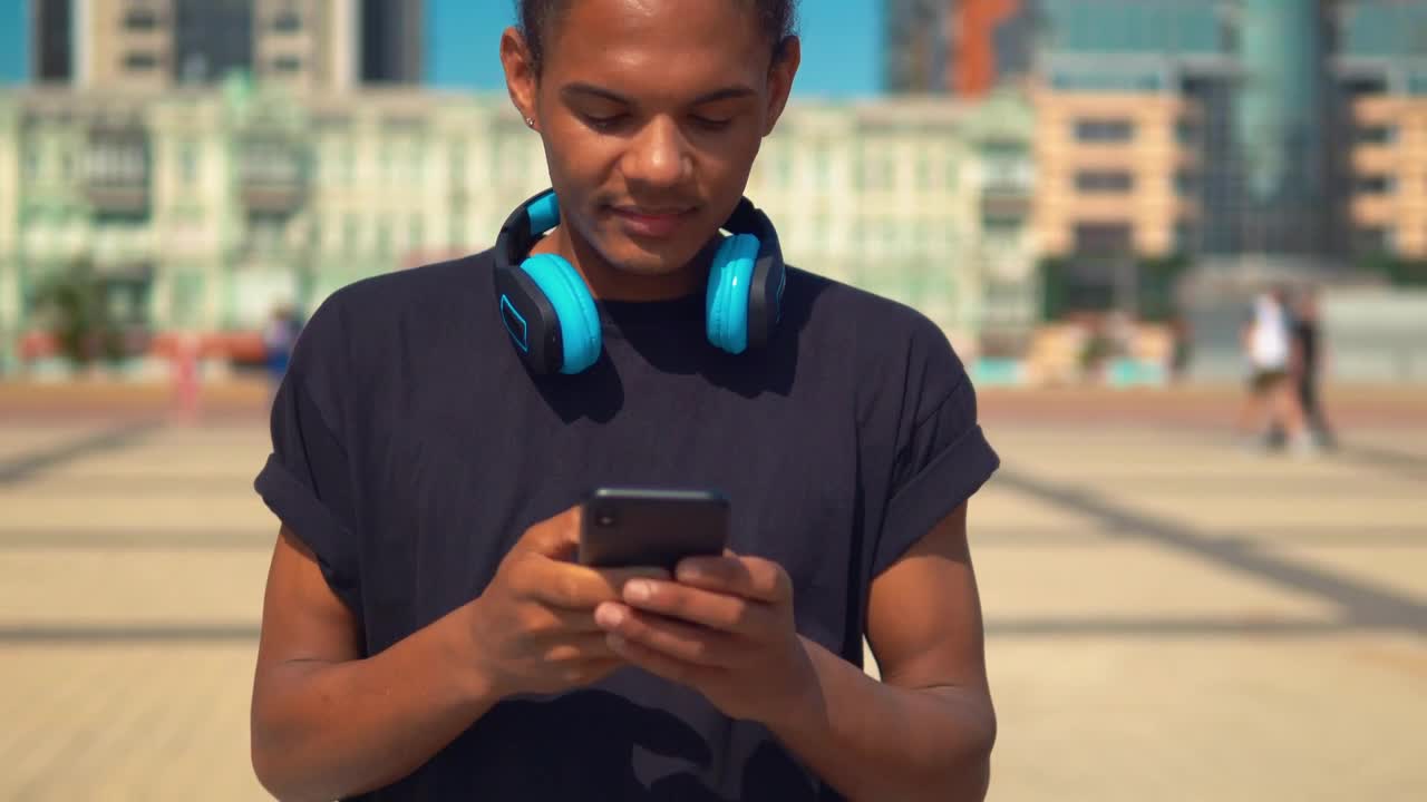 Stock Footage Young Man On The Street Typing On His Cell Phone Live Wallpaper Free