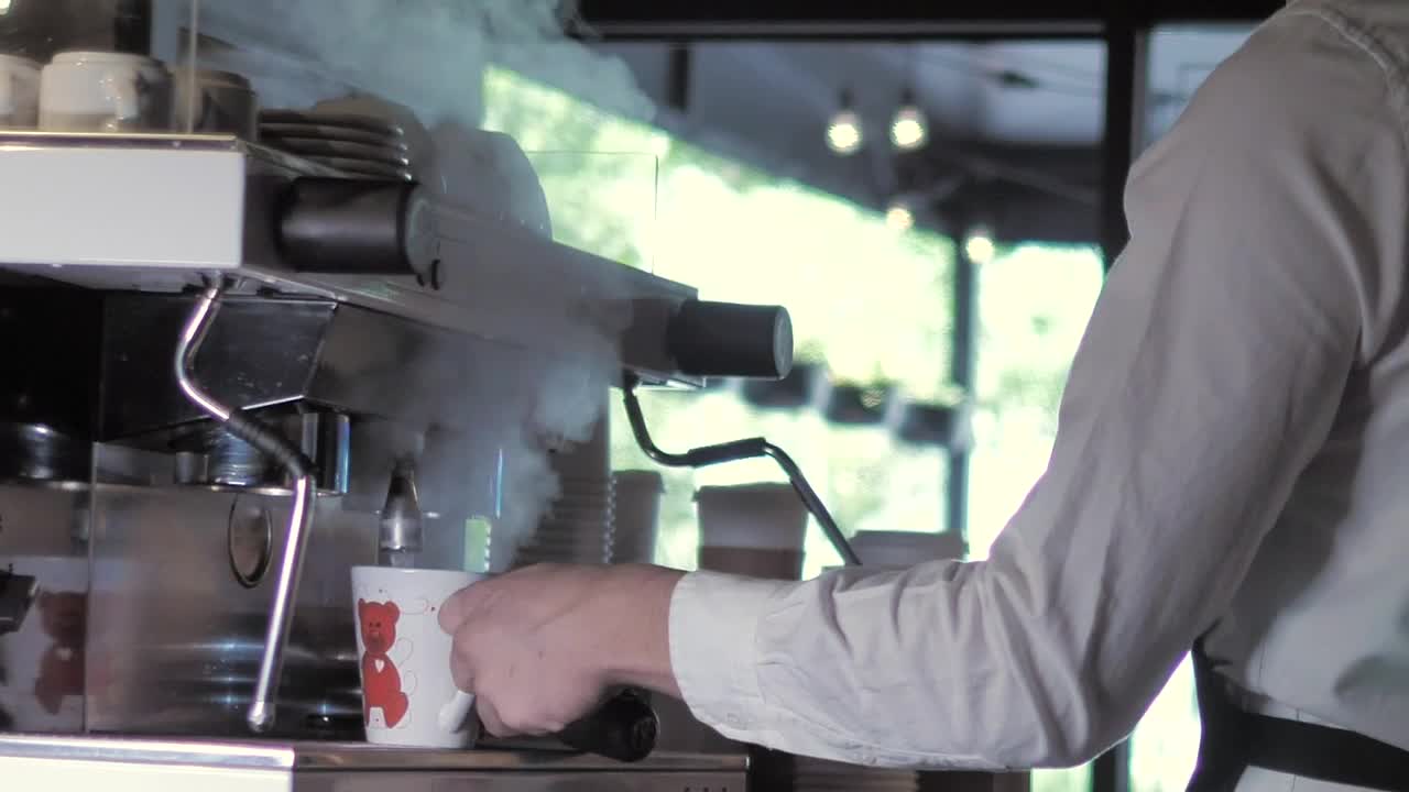 Stock Footage Young Man Serving Hot Coffee Into A Cup Live Wallpaper Free