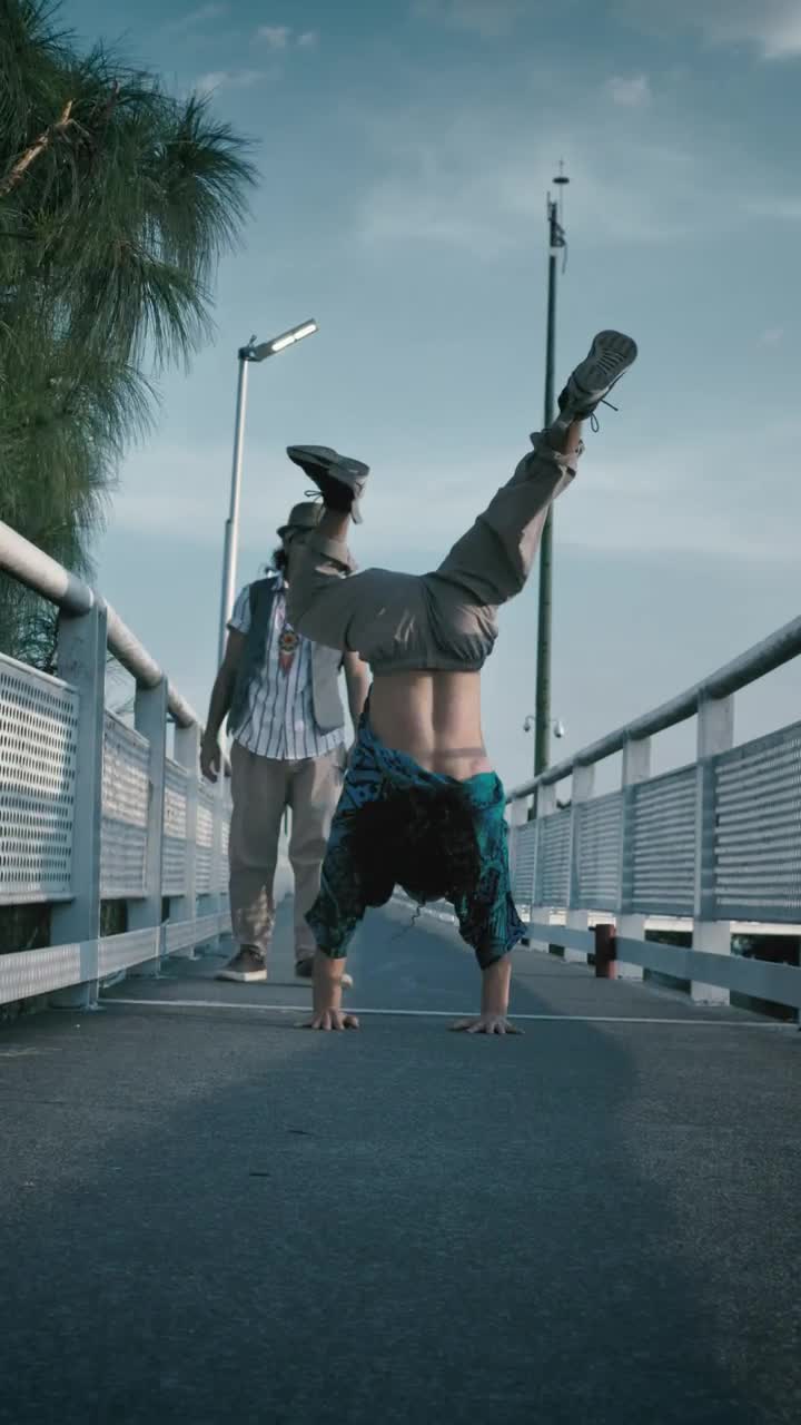 Stock Footage Young Man Dancing Upside Down On A Pedestrian Bridge Live Wallpaper Free