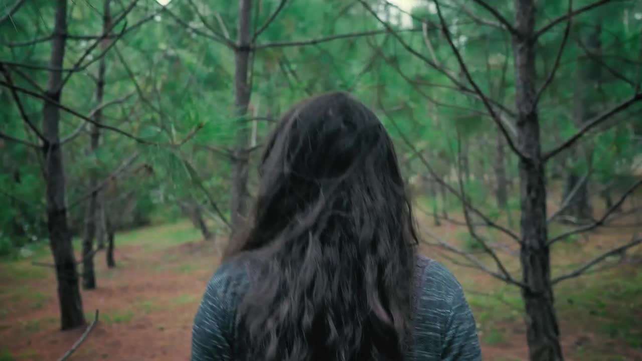 Stock Footage Woman Walking Through The Branches In A Forest Live Wallpaper Free