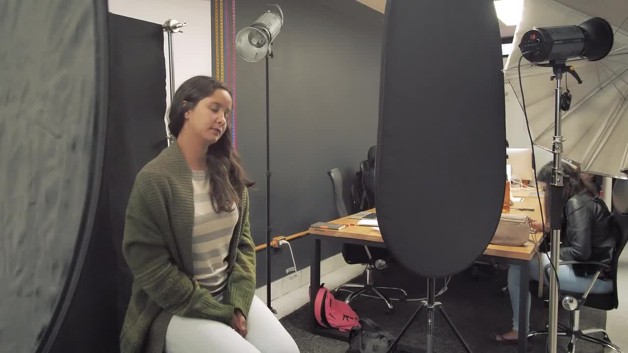 Stock Footage Woman Sitting In A Photo Studio Smiles Live Wallpaper Free