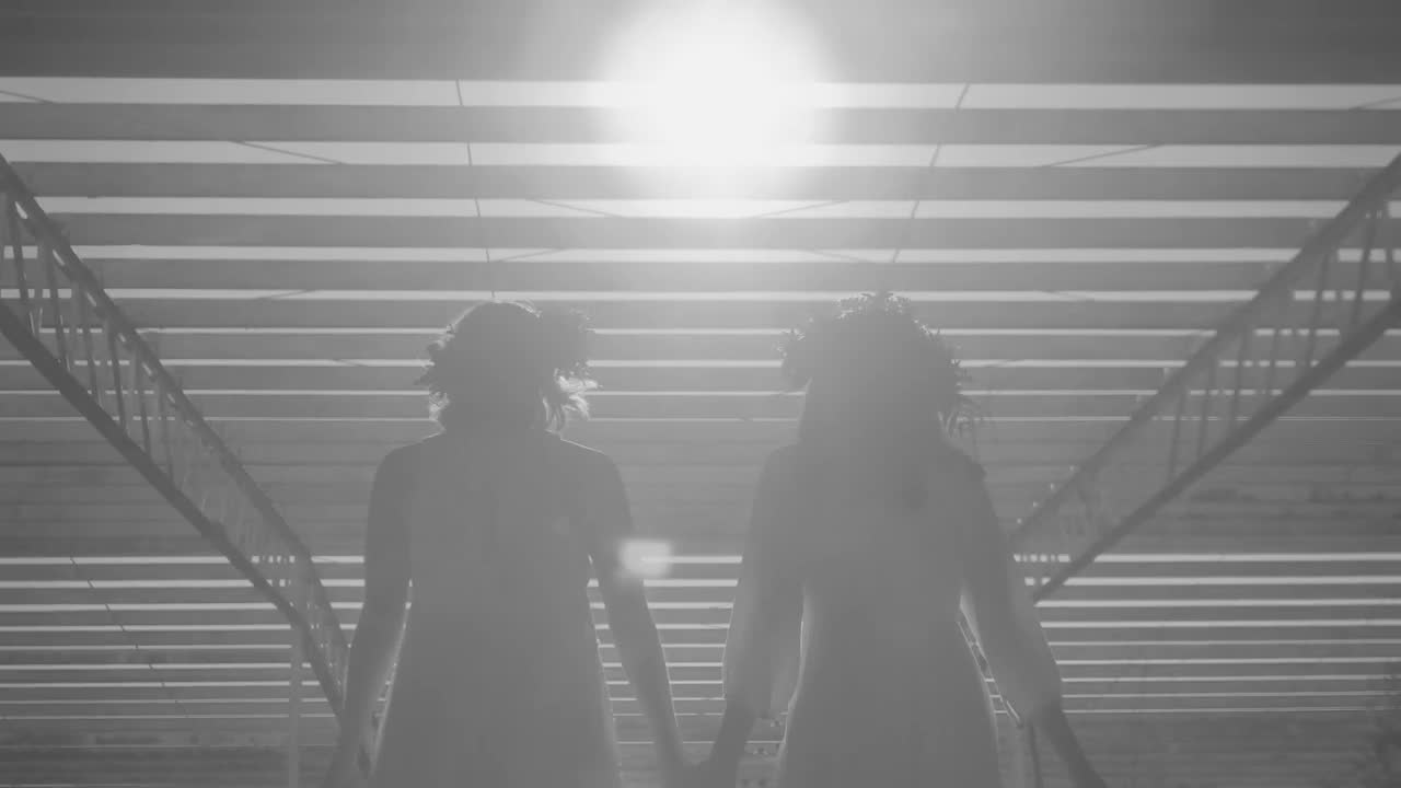 Stock Footage Women Holding Hands Walking In The Sun Under An Industrial Live Wallpaper Free