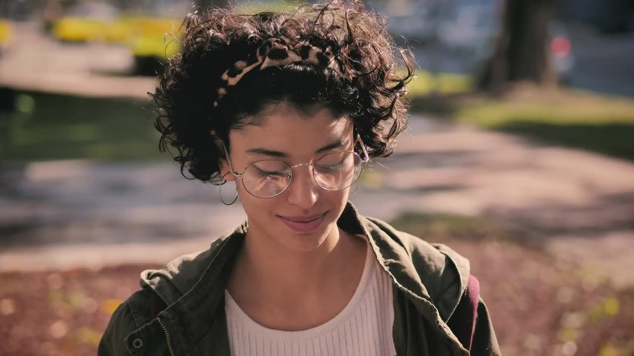 Stock Footage Woman Putting On Headphones In The Park Live Wallpaper Free