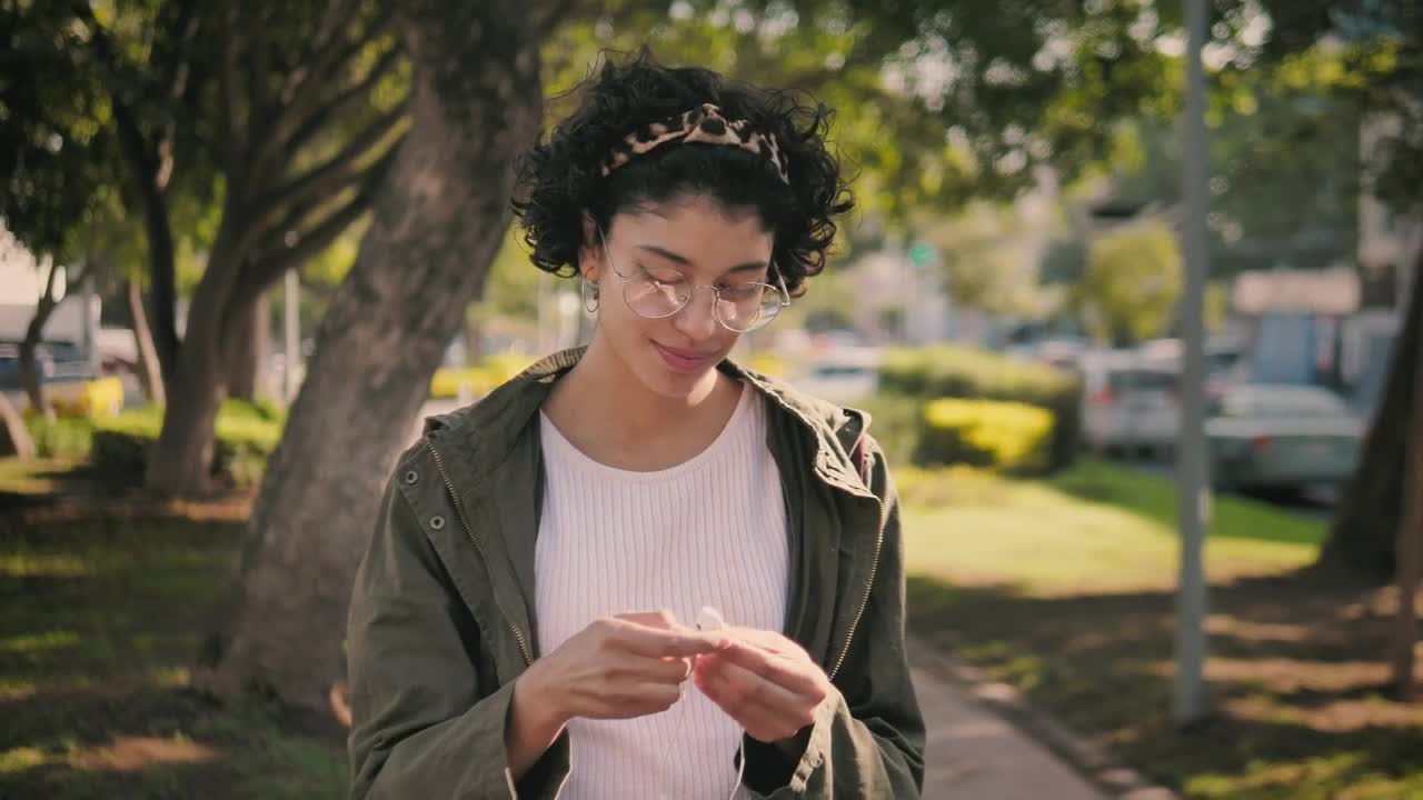 Stock Footage Woman Putting On Headphones While Going For A Walk Live Wallpaper Free