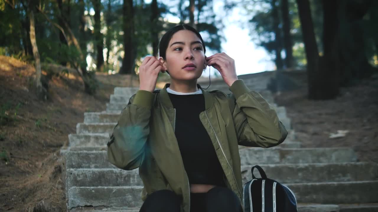 Stock Footage Woman Wearing Active Wear Puts On Headphones Live Wallpaper Free