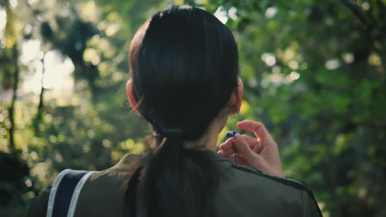 Stock Footage Woman Form Behind Puts On Headphones Live Wallpaper Free