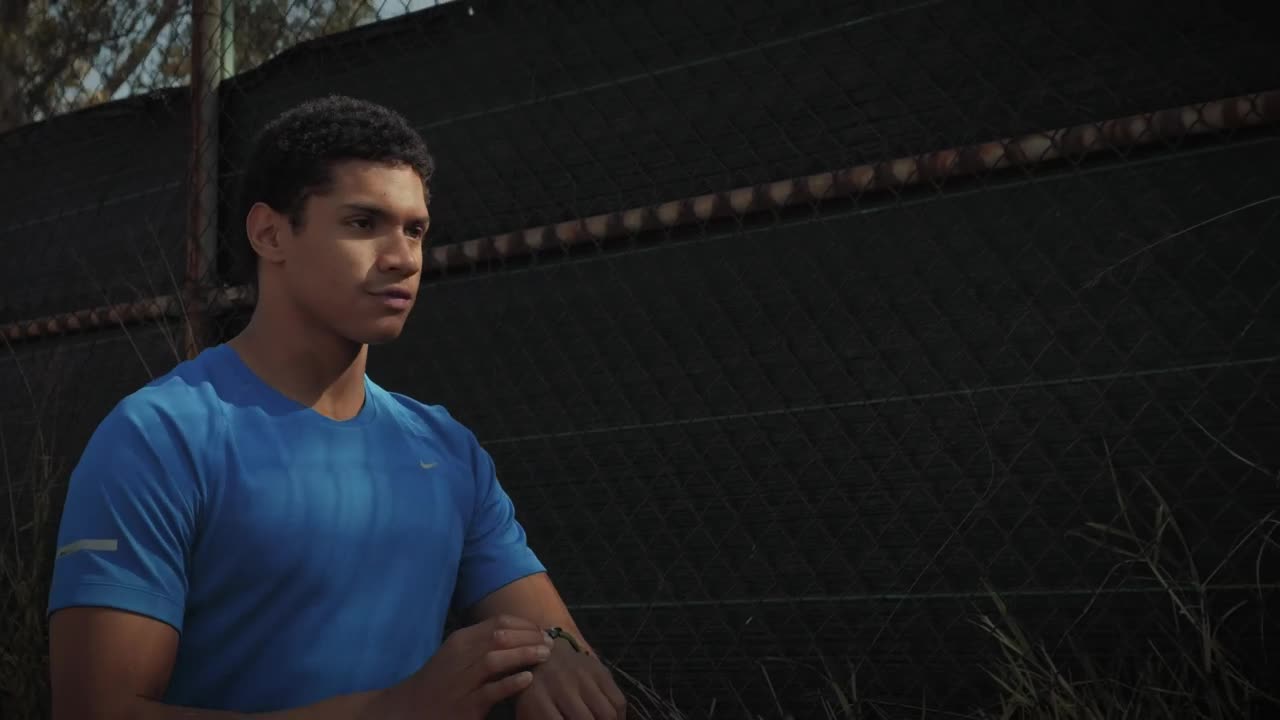 Stock Footage Young Man Jogging In Front Of Chainlink Fence Live Wallpaper Free