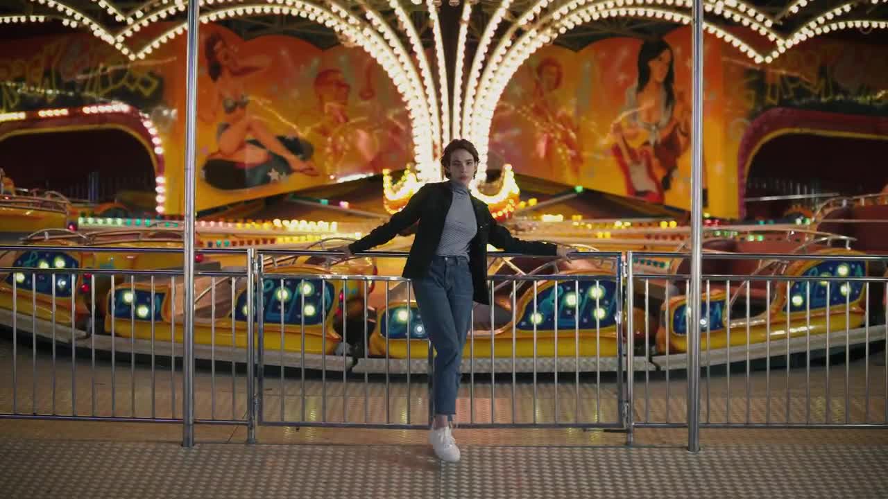 Stock Footage Woman Standing In Front Of Amusement Park Ride Live Wallpaper Free