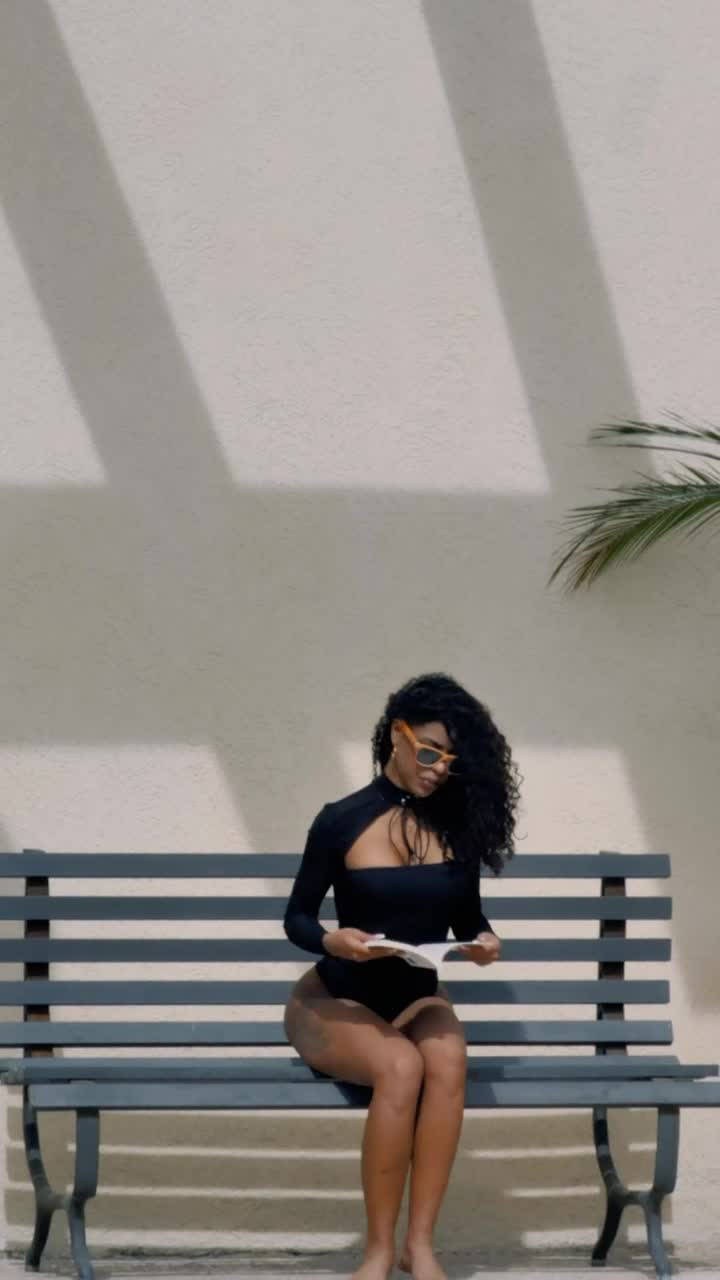 Stock Footage Woman In Swimwear Sitting On A Bench To Read A Live Wallpaper Free