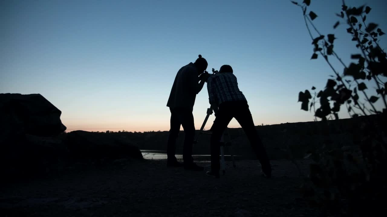 Stock Video A Couple Of Friends Stargazing Using The Telescope Live Wallpaper for PC
