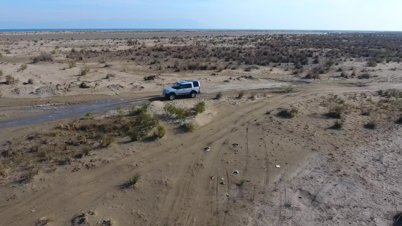 Stock Video Aerial Following Of A Car Passing Through The Water Live Wallpaper for PC