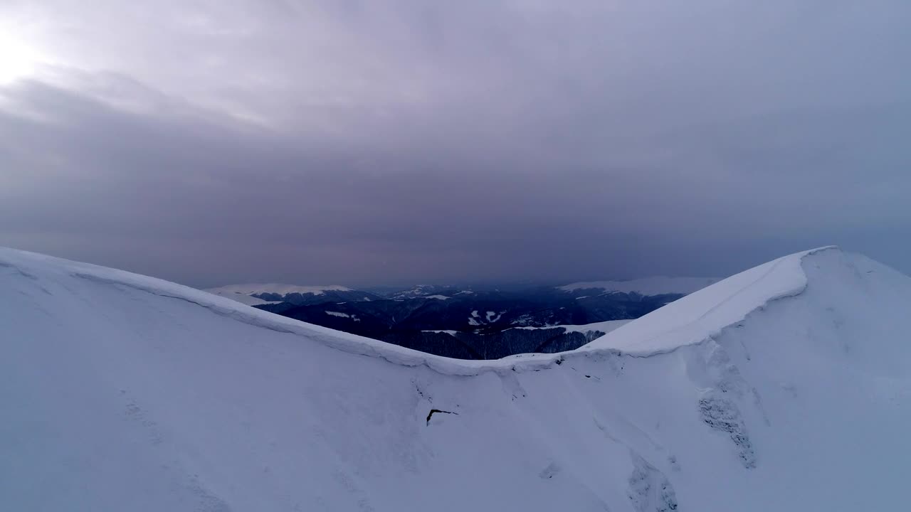 Stock Video Aerial Shot Of The Top Of A Snow Covered Mountain Live Wallpaper for PC