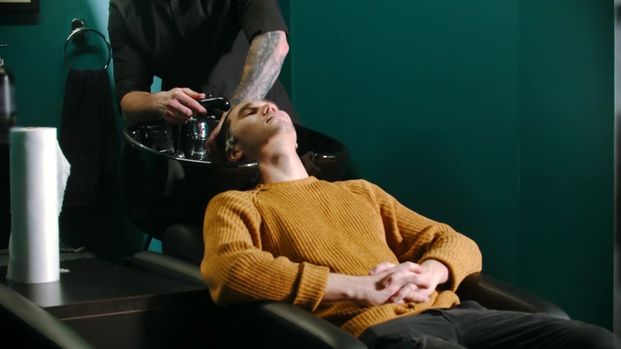 Stock Video Barber Wearing A Mask Washing Clients Hair Live Wallpaper For PC