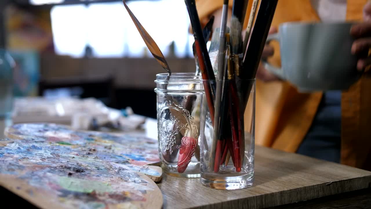 Stock Video Artist Placing A Cup Down In Their Studio Live Wallpaper For PC