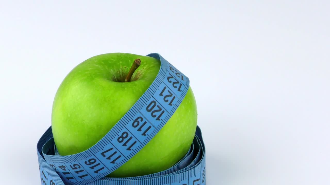 Stock Video Apple And Measuring Tape On White Background Live Wallpaper For PC