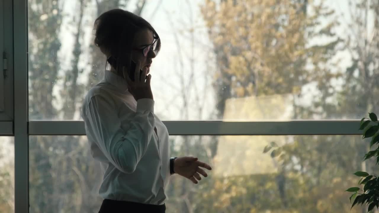 Stock Video A Woman Talking On The Phone Near The Window Live Wallpaper For PC