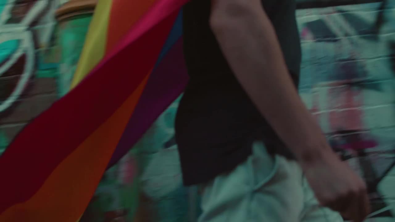 Stock Video A Man With A Rainbow Flag Walking In The Street Live Wallpaper For PC