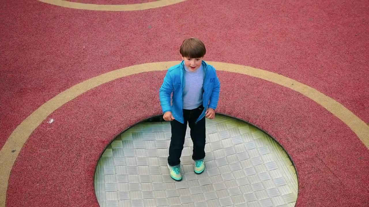 Stock Video A Little Boy Jumping On The Trampoline At The Playground Live Wallpaper For PC