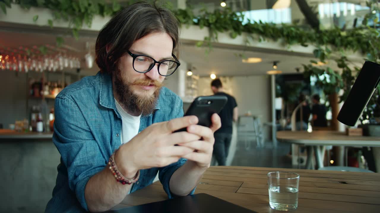 Stock Video Bearded Man Using Mobile App In Airport Cafe Live Wallpaper For PC