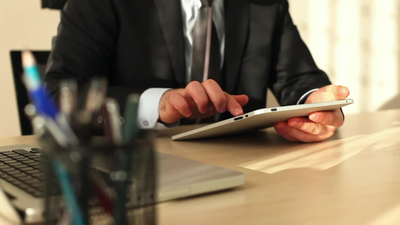Video Stock Businessman In The Office Using His Tablet Live Wallpaper For PC