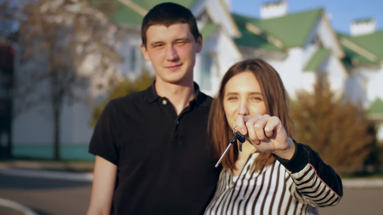 Stock Video Couple Happily Showing Keys To Their New House Live Wallpaper For PC
