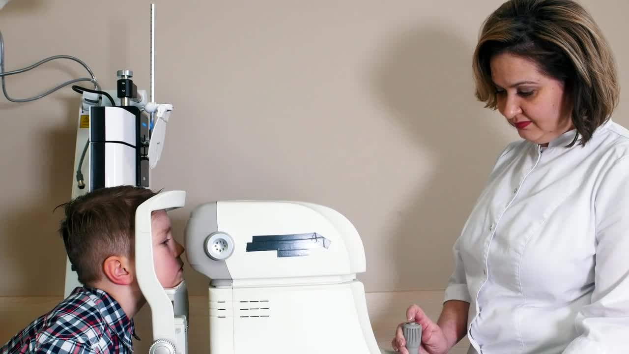 Stock Video Female Ophthalmologist Doing An Eye Exam To A Child Live Wallpaper For PC
