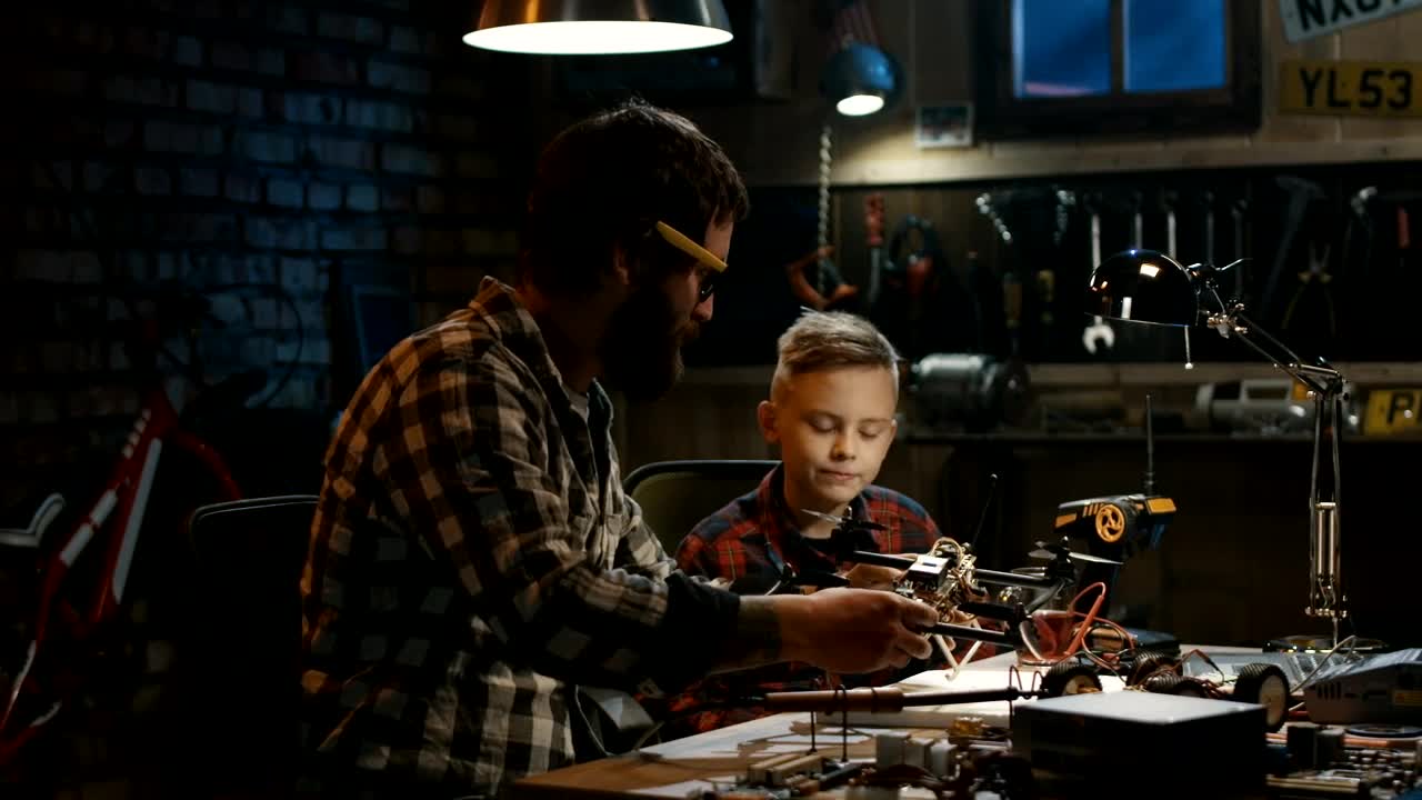 Stock Video Father And Son Repairing A Drone Live Wallpaper For PC