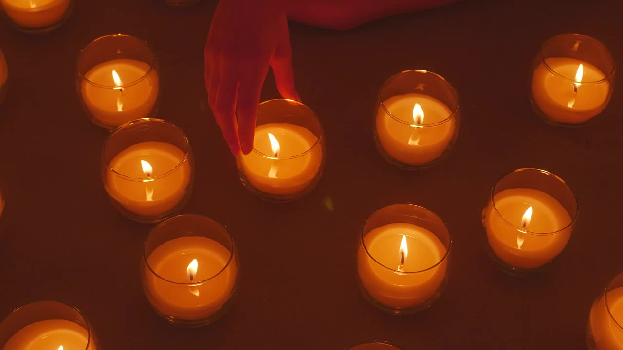Stock Video Hand Of A Lady Arranging Burning Candles Live Wallpaper For PC