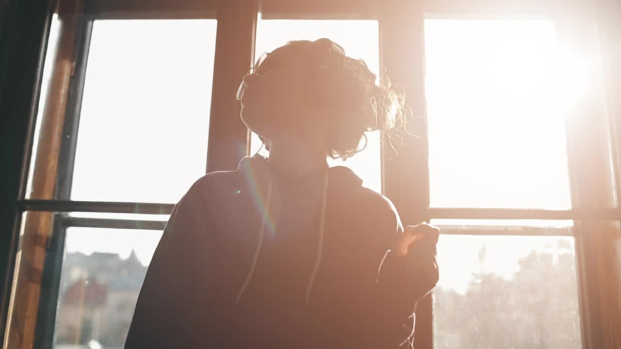 Stock Video Girl Enjoying Music Dances By Sunlit Window Live Wallpaper For PC