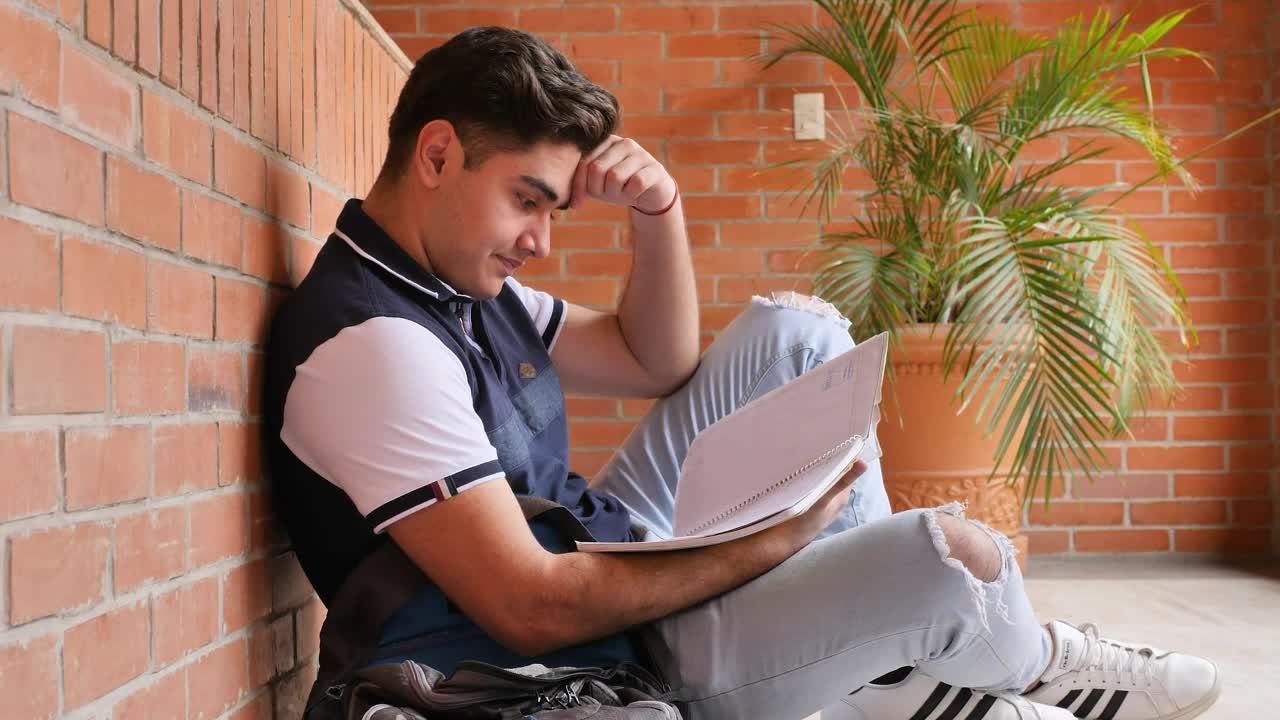 Stock Video Frustrated Student At His School Studying His Notes Live Wallpaper For PC
