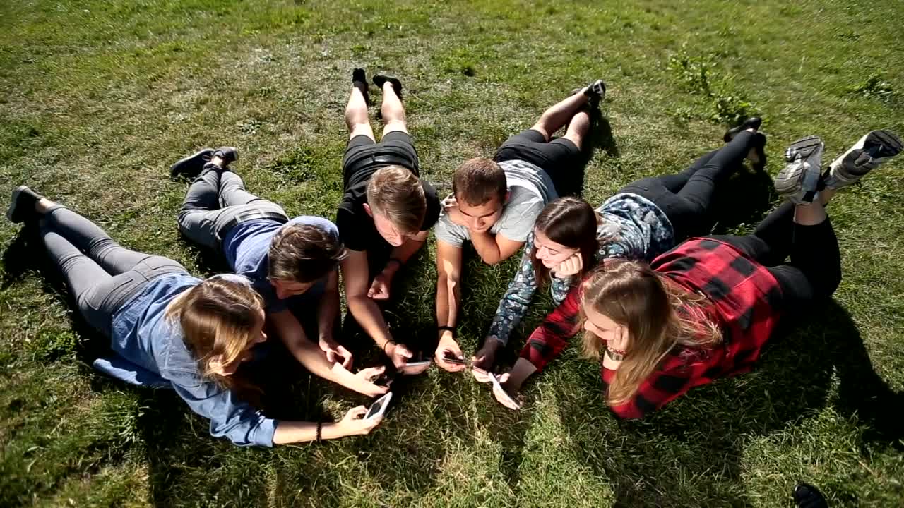 Stock Video Friends With Their Cellphones Lying Outdoors Live Wallpaper For PC