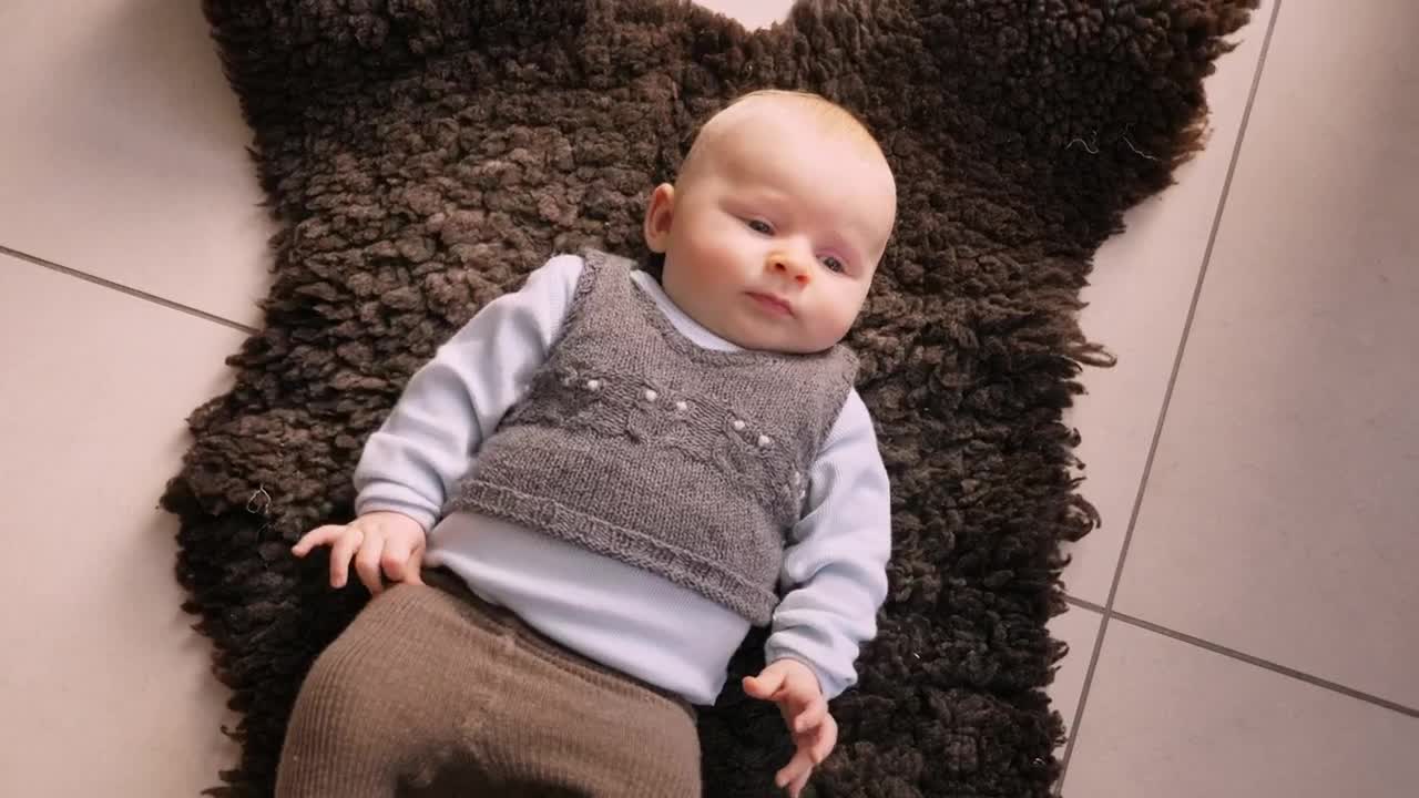 Stock Video Infant Laying On A Rug Animated Wallpaper