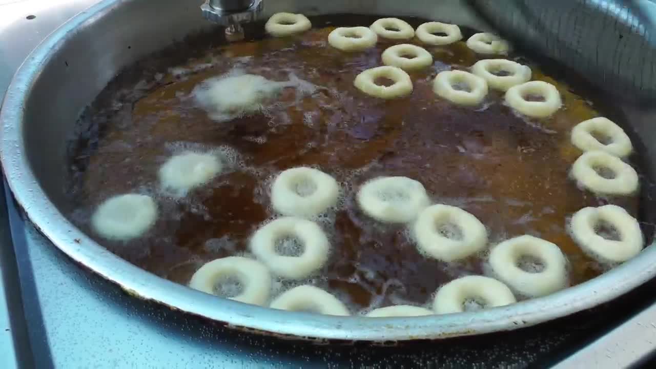 Stock Video Industrial Production Of Fried Donuts Animated Wallpaper