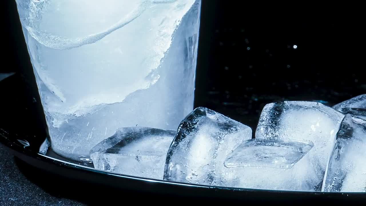 Stock Video Ice Cubes Melting On A Black Surface Animated Wallpaper