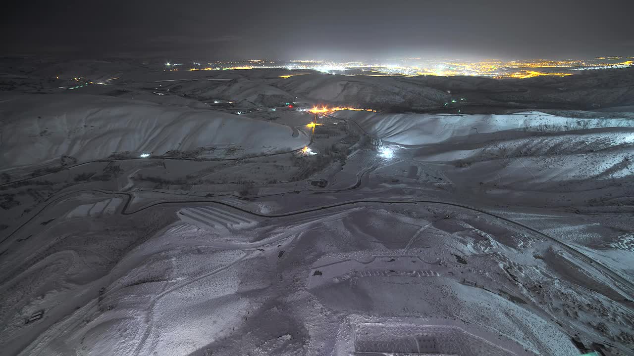 Stock Video Hills Covered In Snow With The City Lights In The Animated Wallpaper