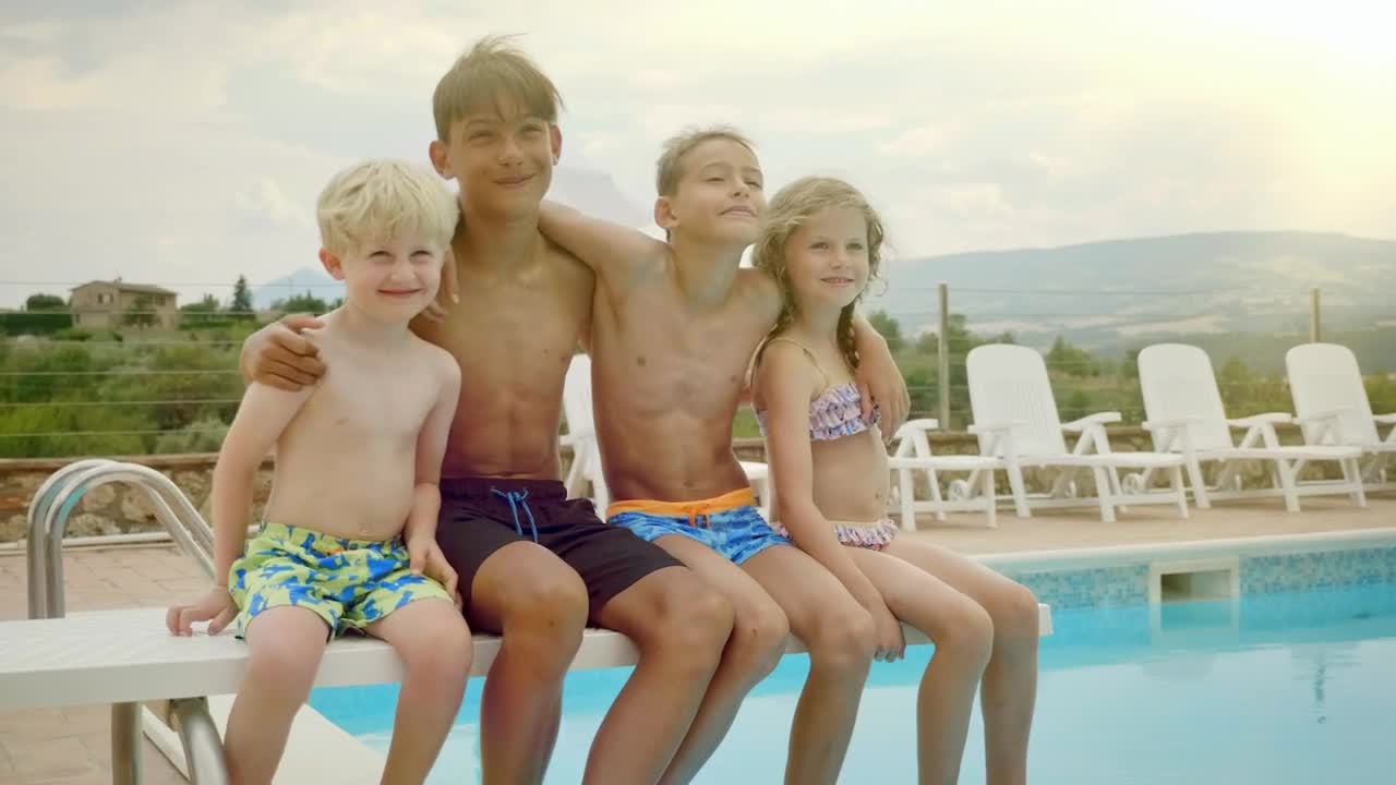 Stock Video Happy Kids Sit On Diving Board Of Pool Posing For Animated Wallpaper