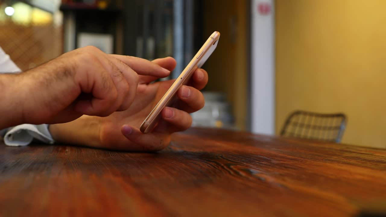 Stock Video Hands Of A Man Using His Cellphone Animated Wallpaper