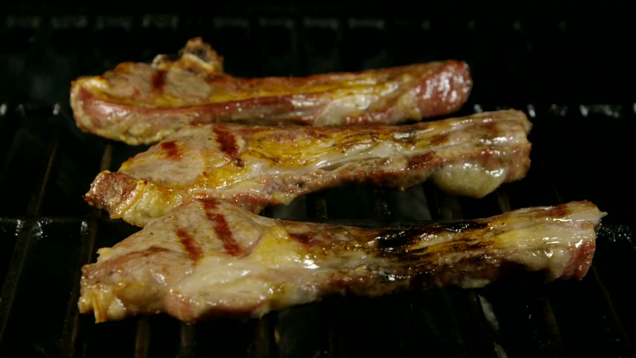 Stock Video Lamb Ribs Cooking On A Grill Animated Wallpaper